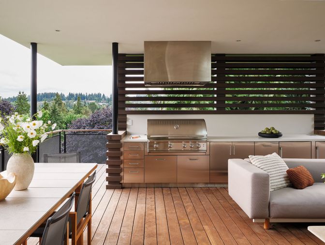 The outdoor lounge has quartz counters and stainless steel cabinets from Danver Outdoor Kitchens, for easy cooking and dining outside.