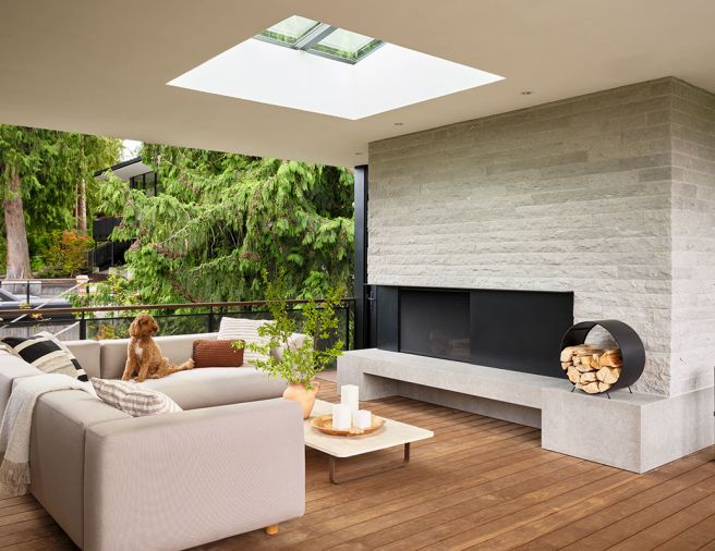 The covered lounge features additional seating and a fireplace with hand-split limestone, a material that is a continuous thread throughout the property.