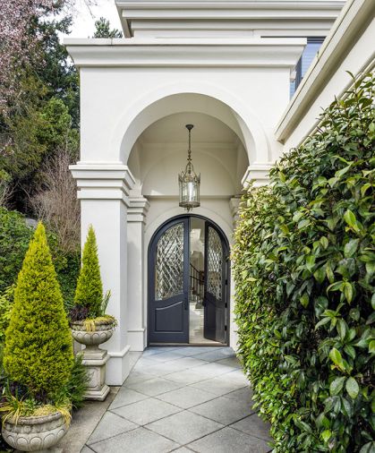 Schultz Miller and LeeAnn Baker Interiors gave this Medina home key updates. An arched entrance with beveled glass doors welcomes guests.