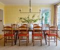 The wall treatment is frequently mistaken for wallpaper, but is a custom crosshatch paint pattern created in collaboration with Robert McAnulty, and finished in &ldquo;Sombrero&rdquo; and &ldquo;Linen White&rdquo; by Benjamin Moore. The wainscoting and trim carpentry throughout is by Iron Ridge Construction.