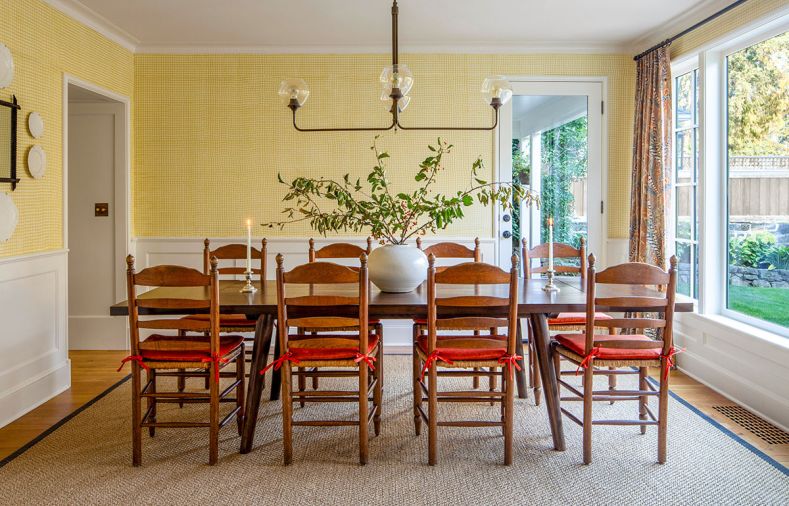 The wall treatment is frequently mistaken for wallpaper, but is a custom crosshatch paint pattern created in collaboration with Robert McAnulty, and finished in &ldquo;Sombrero&rdquo; and &ldquo;Linen White&rdquo; by Benjamin Moore. The wainscoting and trim carpentry throughout is by Iron Ridge Construction.