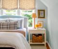 The restive guest suite has custom Roman shades in Claremont fabric by Cindy&rsquo;s Window Fashions.