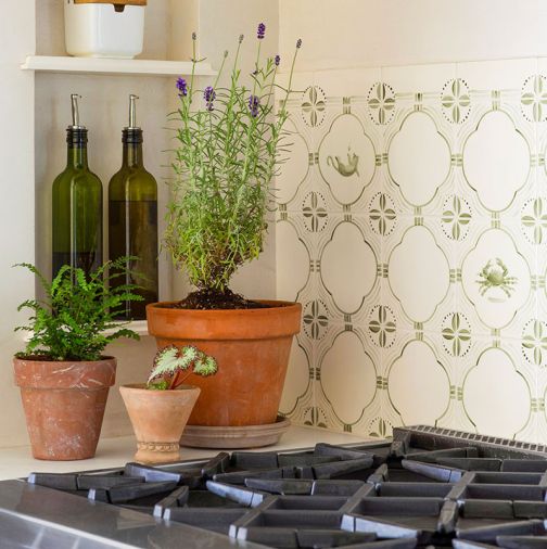 The Delft-style kitchen tile includes custom decorative centers, and was handmade in Portland.