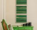 The vintage desk and chair in Shevde&rsquo;s son&rsquo;s room is painted in &ldquo;Parisian Green&rdquo; by Sherwin Williams, and topped with framed sections of hand-painted Fromental silk wallpaper.