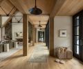 The project team brought in a medley of woods to anchor the main room, from the timber trusses to the white oak flooring found throughout, which is from Montello Design .The pendant lights are from CB2 and lining the walkway is a soft neutral runner underfoot.