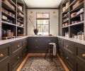 The custom cabinetry in the &ldquo;workhorse&rdquo; of a dry pantry was fabricated by Crystal Cabinets, who did the cabinetry throughout. The cabinetry is painted in Sherwin Williams &ldquo;Muddled Basil&rdquo; with brass Armac Hardware from Chown Hardware. The rug is from Andonian Rugs, while the sconces were found at Lostine.