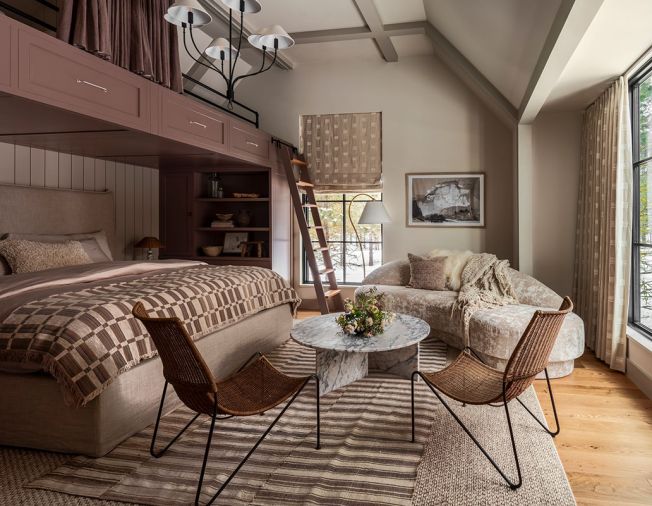 In the &ldquo;Summer Room,&rdquo; Artisan Inc. installed custom bunks using cabinetry by Crystal Cabinets, painted in Sherwin Williams &ldquo;Velvety Chestnut.&rdquo; The walls are painted in Benjamin Moore &ldquo;Ballet White,&rdquo; as a backdrop for the textural Lee Industries sofa from J Garner Home.