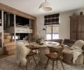 In the &ldquo;Fall Room,&rdquo; Artisan Inc. fashioned custom stairs between the bunks for easy access to the top bunks. At the travertine table, the Four Hands chairs are from J Garner Home and are atop a wool rug. The custom wardrobe is from Vintage Mill Werks.