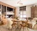 In the &ldquo;Fall Room,&rdquo; Artisan Inc. fashioned custom stairs between the bunks for easy access to the top bunks. At the travertine table, the Four Hands chairs are from J Garner Home and are atop a wool rug. The custom wardrobe is from Vintage Mill Werks.