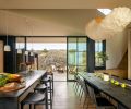 An 11-foot carbonized wood table by Orcas artist Laura Yeats and custom lighting by Bellevue artist Yuri Kinoshita are showstoppers. Fleetwood sliding doors from Cherry Creek Windows & Doors separate the sheltered front courtyard from the interior living space.