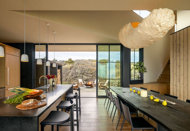 An 11-foot carbonized wood table by Orcas artist Laura Yeats and custom lighting by Bellevue artist Yuri Kinoshita are showstoppers. Fleetwood sliding doors from Cherry Creek Windows & Doors separate the sheltered front courtyard from the interior living space.
