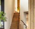 The stair landing provides custom storage, while the walls throughout are painted &ldquo;Alaskan Skies&rdquo; from Benjamin Moore.