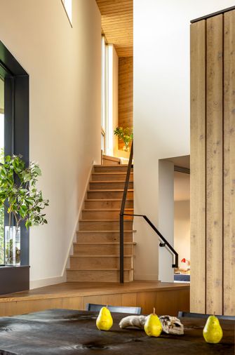 The stair landing provides custom storage, while the walls throughout are painted &ldquo;Alaskan Skies&rdquo; from Benjamin Moore.