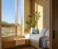 The corner window seat and reading nook, in the kids&rsquo; domain, is backed by Western red cedar and is cozied with a blanket from Pendleton Woolen Mills.