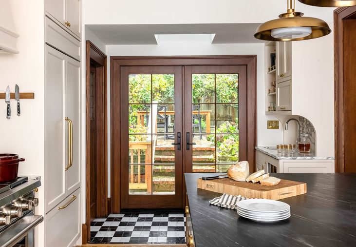 Most of the kitchen&rsquo;s hard-working appliances are hidden by paneling to reduce the cold feel of steel in the renovated kitchen, bringing a clean look and seamless style.