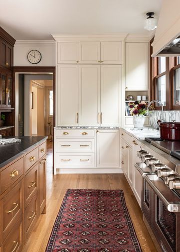 The custom cabinetry is painted in Sherwin Williams &ldquo;Steamed Milk&rdquo; and adorned with unlacquered brass hardware from Rejuvenation. The heart of the kitchen is a soapstone countered island featuring the same brass touchpoints.