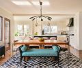 What better way to make entertaining easier than opening the former tiny 1980s remodeled kitchen to the spacious dining room. A blackened original radiator pops against hair-on-hide-rug from Surya and a Dedar fabric upholstered black bench for relaxed dining.