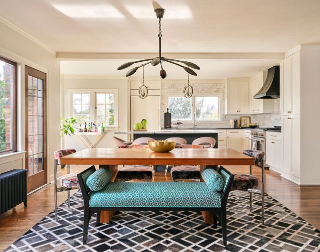 What better way to make entertaining easier than opening the former tiny 1980s remodeled kitchen to the spacious dining room. A blackened original radiator pops against hair-on-hide-rug from Surya and a Dedar fabric upholstered black bench for relaxed dining.