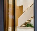 Homeowners chose the custom stone mix for the Venetian Terrazzo Co. floors throughout. A mid-century style indoor planter grounds and softens the sensuously curved staircase with custom railing created by MW Design Workshop.