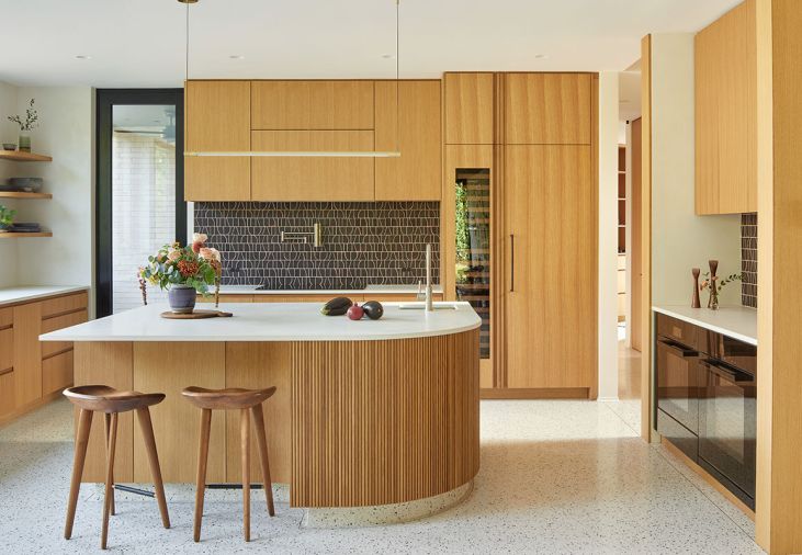 Striking MakuMade Malaga tile from Tempest Tileroom pops against Cement Elegance concrete counters and warm custom rift-sawn white oak cabinetry by Big Branch Woodworking. Eastbank Contractor Appliances supplied Wolf, Miele, Sub-Zero and Cove appliances.