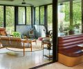 The greenroom features Weiland LiftSlide doors and Kolbe Low-E windows from Portland Millwork. Ann Sacks &ldquo;Fantastique&rdquo; tile backs a Mors&oslash; stove. The inviting kitchen banquette features Spinneybeck Vicenza burgundy leather.