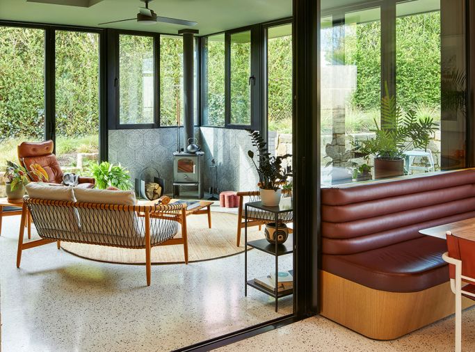 The greenroom features Weiland LiftSlide doors and Kolbe Low-E windows from Portland Millwork. Ann Sacks &ldquo;Fantastique&rdquo; tile backs a Mors&oslash; stove. The inviting kitchen banquette features Spinneybeck Vicenza burgundy leather.