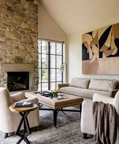 In the living room, an Arden Home sofa and a vintage rug from Driscoll Robbins Fine Carpets grounds the space, while roller shades from Hartmann & Forbes hang discreetly at the windows.