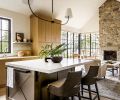 The kitchen island is covered in metallic paint with a rubbed effect by Morgan&rsquo;s Fine Finishes, and topped with a Caesarstone Quartz counter. The leather stools are from Palecek, and overhead, there&rsquo;s a Crane Double Pendant from The Urban Electric Co.