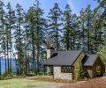 The exterior, with elegant crisp black aluminum windows and doors, and a smooth standing seam metal roof is juxtaposed against Italian salvaged stone. The project focused on weaving in threads from the homeowner&rsquo;s life experience.