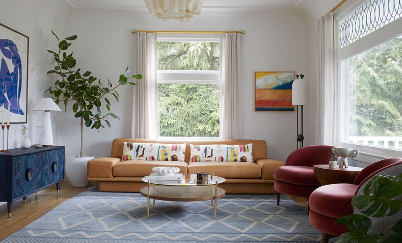 Natural light is abundant from windows restored by East Portland Sash. Color is inserted with Belle Side Chairs from DeMuro Das, a StudioTwentySeven&rsquo;s Moore + Giles sofa, Gulliver Media Console, and custom rug from Taylor Made Textiles.