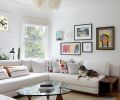 Adding comfort, Bright Designlab designed a custom sofa paired with an abaca fiber Anders Pendant from Pinch and a Noguchi coffee table. The historic stained glass window hails from the homeowner family&rsquo;s old home.