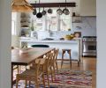 A vintage bamboo and rice paper Uchiwa Fan Pendant lights a walnut extension table designed by Bright Designlab and built by Master Furniture Makers. The Jan Kath rug from Christiane Millinger adds dimension.