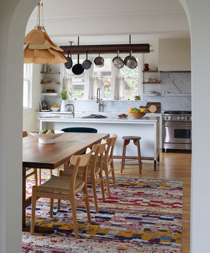 A vintage bamboo and rice paper Uchiwa Fan Pendant lights a walnut extension table designed by Bright Designlab and built by Master Furniture Makers. The Jan Kath rug from Christiane Millinger adds dimension.