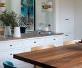 The custom ash built-in with shaker flat front panels and clean subtitle knobs is from Edel Design Center. A mirror above reflects the dramatic &ldquo;Joshua&rdquo; artwork by Kristin Hart Studios.