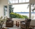 The new family room&rsquo;s Pella windows provide views of Seattle across Lake Washington. The comfy Wesley Hall Fremont swivel chairs and leather Durham storage ottoman are from DFG.