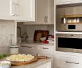 &ldquo;Pizza Night&rdquo; celebrations await in the kitchen, that is lined with a herringbone Walker Zanger, Tangent Hive mosaic Calacatta backsplash from United Tile, with returns in Calacatta Classico. Schaub Menlo Park Collection hardware dresses the cabinets.