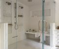 The double steam shower features polished nickel Kohler fixtures from Ferguson Home. Shower walls are lined in &ldquo;Matte White&rdquo; Sonoma Tilemakers Pure tile. The shower floor is covered in Pietra Bella &ldquo;Bianco Bello&rdquo; and shower boxes are trimmed with Tangent Hive Calacatta, both from Walker Zanger.