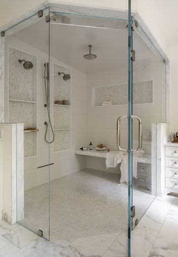 The double steam shower features polished nickel Kohler fixtures from Ferguson Home. Shower walls are lined in &ldquo;Matte White&rdquo; Sonoma Tilemakers Pure tile. The shower floor is covered in Pietra Bella &ldquo;Bianco Bello&rdquo; and shower boxes are trimmed with Tangent Hive Calacatta, both from Walker Zanger.