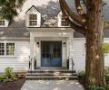 The reconfigured entry door, now painted in Sherwin Williams &ldquo;Smoky Blue,&rdquo; was pushed out to match the line of the exterior. The house is dressed in Benjamin Moore &ldquo;Simply White,&rdquo; and the roofing refinished with Presidential Shake TL by CertainTeed. A new walkway of Marenakos Stone pavers lead the way.