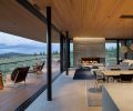 The home&rsquo;s key grounding architectural element is its stunning board-formed concrete chimney by Deschutes Concrete. A 40  Glasbox slider opens interiors to an Ipe deck with Gloster Kay High Back Rocking Chairs.
