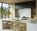 Sleekly designed kitchen cabinets by FQ Designs and built by Anderson Clark Interiors plays off the hand-fabricated hood cover by MW Design Workshop. Miele cooktop, refrigerator, range, and dishwasher are from Johnson Brothers.