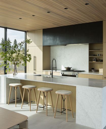 Sleekly designed kitchen cabinets by FQ Designs and built by Anderson Clark Interiors plays off the hand-fabricated hood cover by MW Design Workshop. Miele cooktop, refrigerator, range, and dishwasher are from Johnson Brothers.