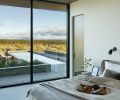 Breakfast in the Bonaldo River guest bed by Nido Living before a dip in the pool is a great way to start a High Desert day. &ldquo;Chantilly Lace&rdquo; wall color by Benjamin Moore bounces light across the cozy sheets and duvet from Parachute.