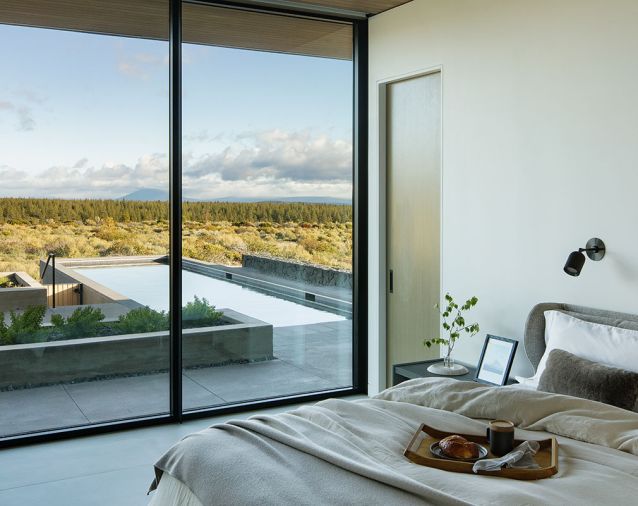 Breakfast in the Bonaldo River guest bed by Nido Living before a dip in the pool is a great way to start a High Desert day. &ldquo;Chantilly Lace&rdquo; wall color by Benjamin Moore bounces light across the cozy sheets and duvet from Parachute.