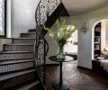 The custom staircase was designed and fabricated by Twisted Metalworks, Inc, with tile from the Pacific Register Company. The engineered wood floors are from Simply Oak, and the Branch sconce was sourced at Visual Comfort & Co.