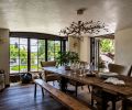 The dining area was reoriented so as to embrace the view into the backyard, and ensure space for entertaining. Double doors open to the covered patio with outdoor dining.