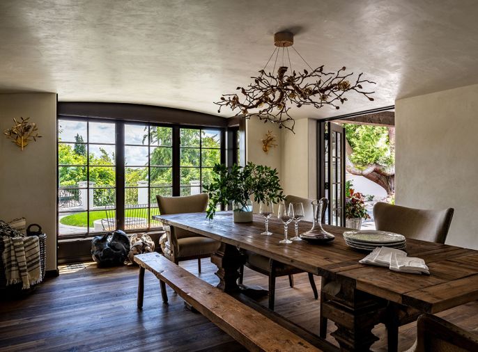 The dining area was reoriented so as to embrace the view into the backyard, and ensure space for entertaining. Double doors open to the covered patio with outdoor dining.