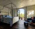 The primary bedroom has access to the backyard via doors to the terrace.