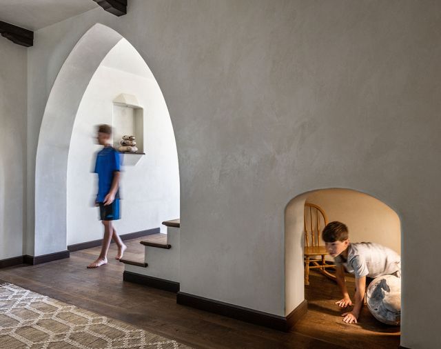 Downstairs, a secret passageway is accessed by an arched alcove at the floor.