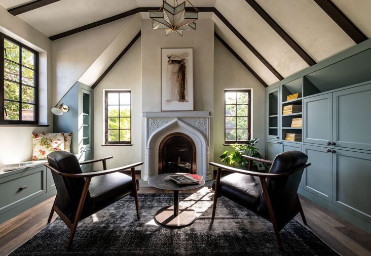 In the sitting room, the custom casework is from Scott Faulkner Design with knobs from House of Antique Hardware. The fireplace is cast plaster, with a Glass Star Chandelier above. At the window seat, there&rsquo;s a Princeton Mid Sconce in natural brass from Schoolhouse.